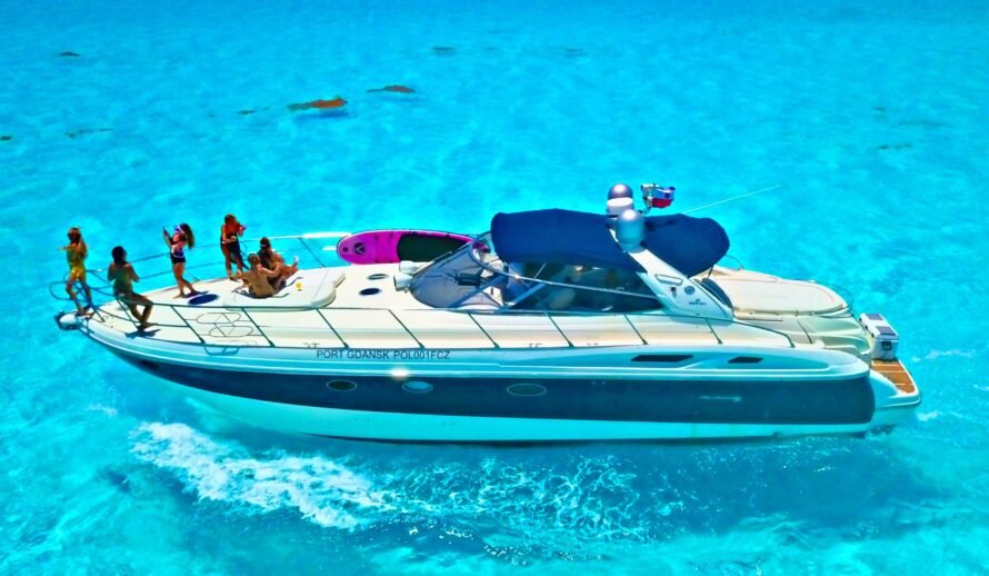 Luxury 60ft yacht rental in Cancun – Diva yacht with guests relaxing and swimming in turquoise water