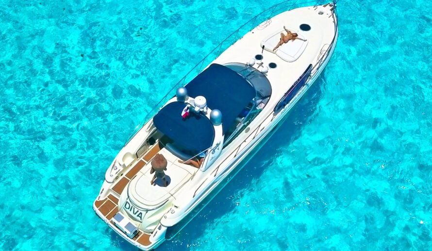 Luxury 60ft yacht rental in Cancun – Diva yacht top view with guest sunbathing on deck in Caribbean water