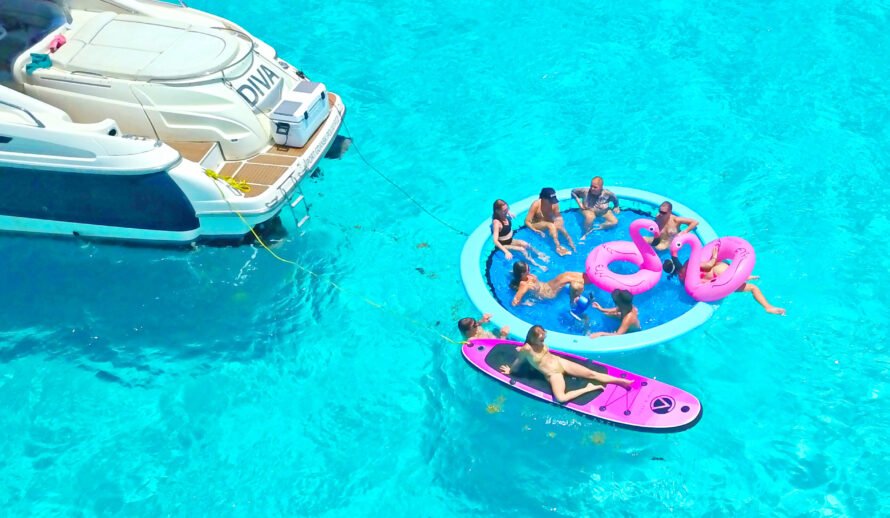 Luxury 60ft yacht rental in Cancun – Diva yacht guests enjoying floating party with water toys in Caribbean sea