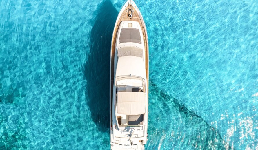 Ferretti 72 yacht aerial top view in Cancun crystal clear turquoise water